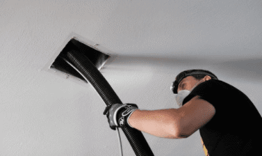 man cleaning duct