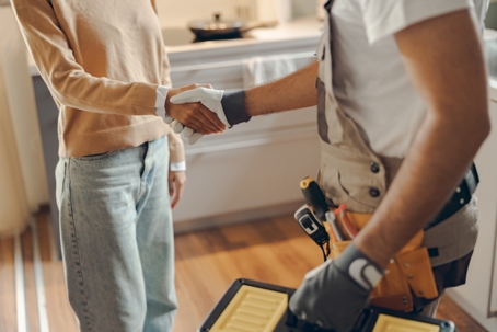 serviceman and woman shaking hands