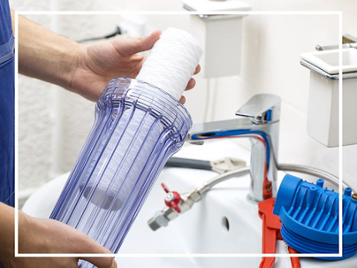 Plumber installing water filter