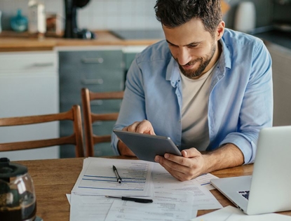 man smiling looking at AC bill