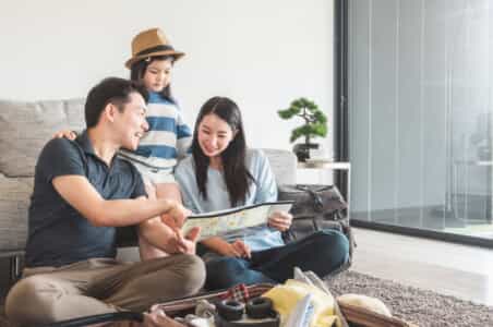 Family looking at a paper.