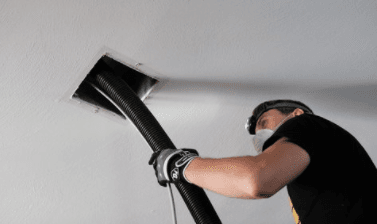 man cleaning duct