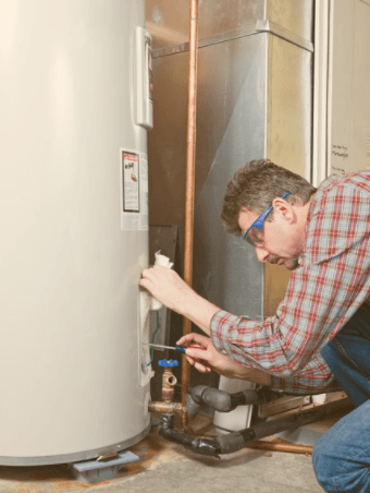 man inspecting water heater