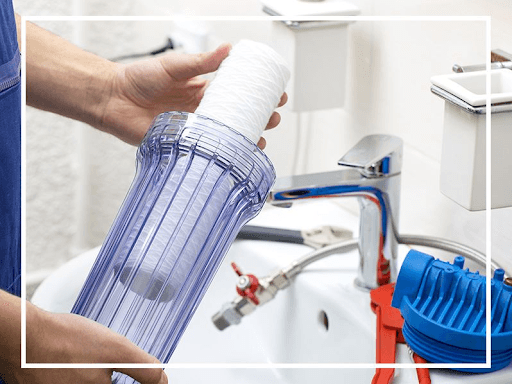 Plumber installing water filter